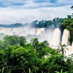 waterfall-iguazu-national-park-surrounded-by-forests-covered-fog-cloudy-sky_181624-17382