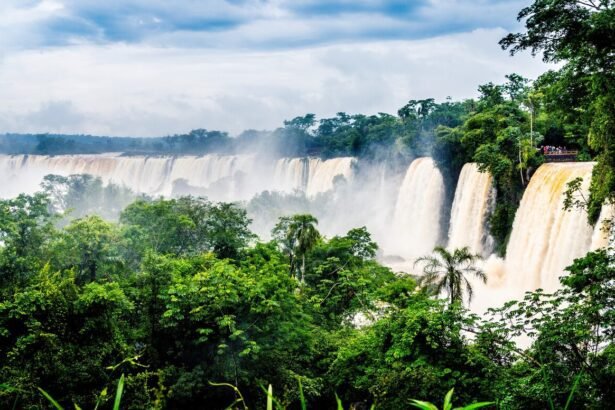 waterfall-iguazu-national-park-surrounded-by-forests-covered-fog-cloudy-sky_181624-17382